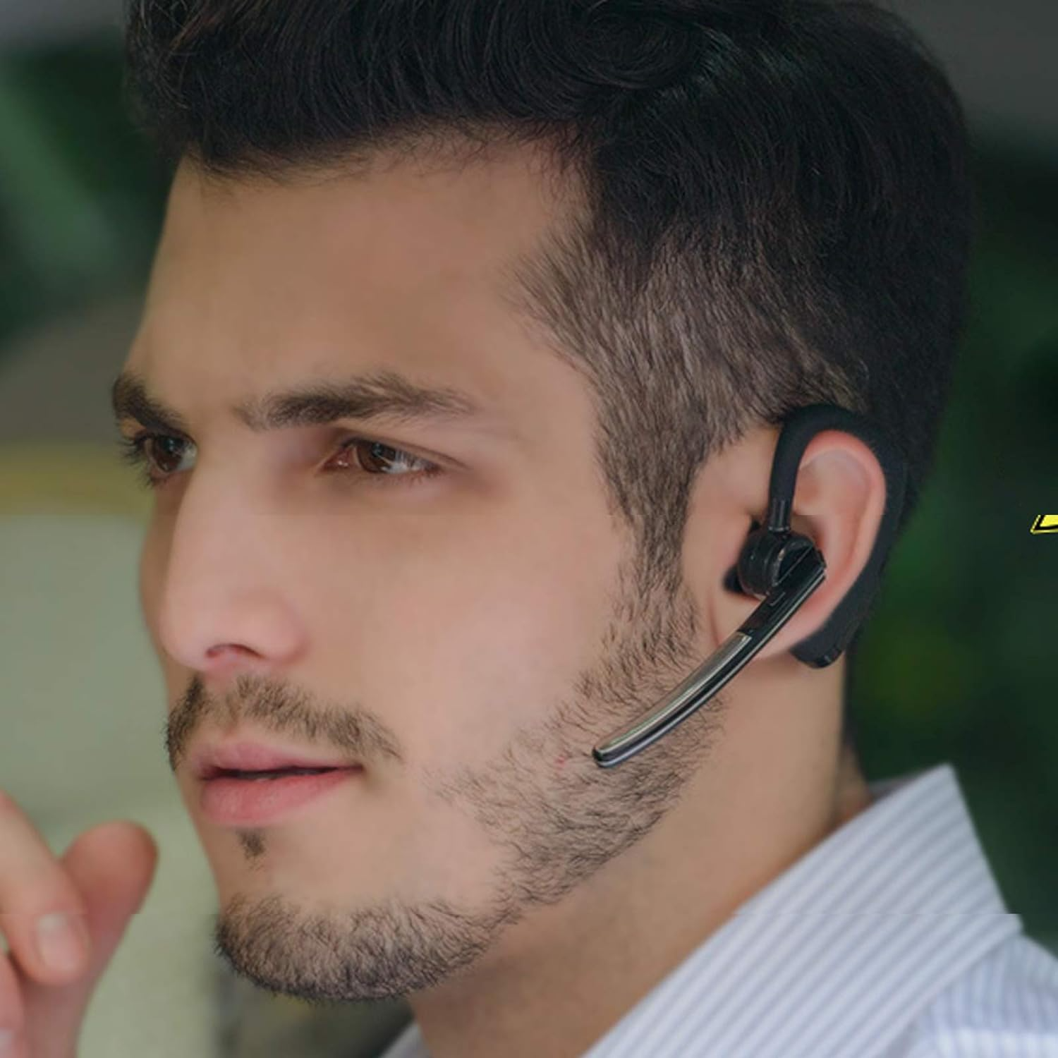 Man wearing Bluetooth Earpiece outdoors – noise cancelling wireless headset in use